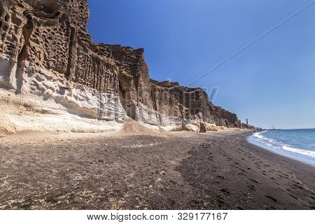 Canyon Mountains And Sea With Black Volcanic Beach On Vlychada.