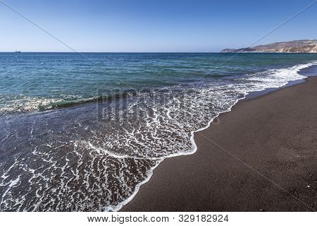 Sea Surf On The Beach With Black Volkanic Sand.