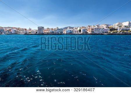 Agios Nikolaos On A Sunny Day With Clear Sea And Cliffs. Elunda.