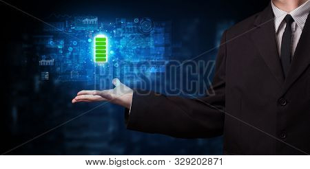 Elegant hand holding battery with full of energy
