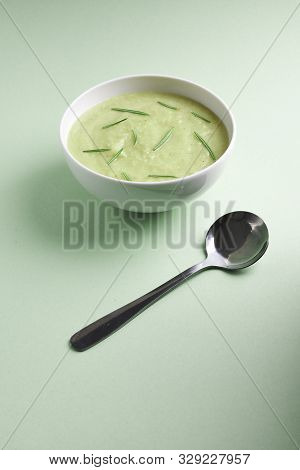 Bowl With Squesh Cream Soup On Lightgreen Background