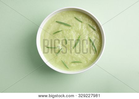 Bowl With Squesh Cream Soup On Lightgreen Background