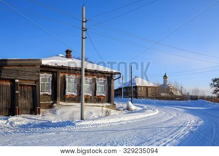 Visim, Russia - January 8, 2015. Snow-covered Winding Village Street In Winter. Old Residential Neig
