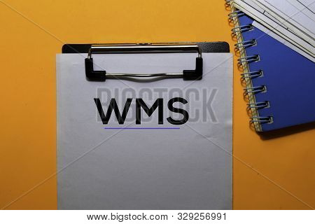 Wms Write On Paperwork. Isolated On Orange Table Background