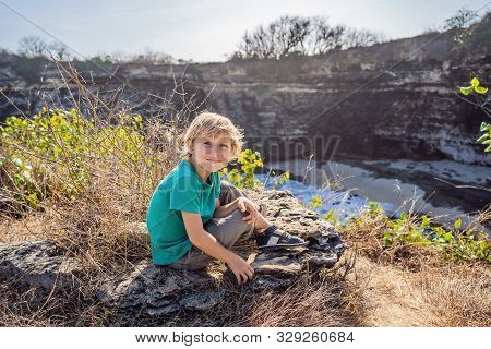 Young Boy Tourist Near Broken Beach In Nusa Penida, Indonesia Angels Billabong Beach. Popular Touris