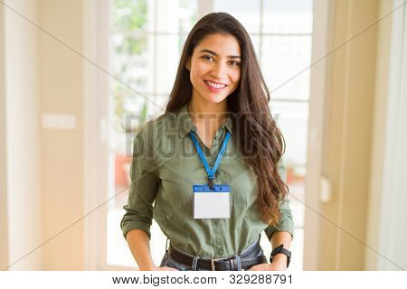 Beautiful young business woman wearing id card
