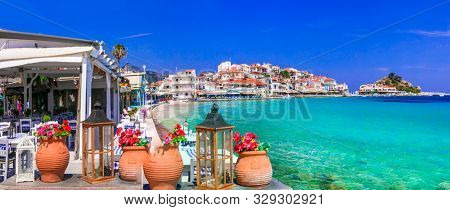 Most beautiful traditional villages of Greece - Kokkari in Samos island, view with seaside tavern