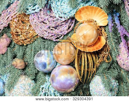 Christmas Decorations In A Marine Style Closeup. Glass Christmas Baubles In Shape Of Sea Large Pearl
