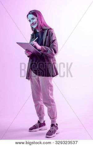 Modern Girl With Laptop, Tablet Computer. Free Creativity. A Young Blogger Makes A Home Office. Colo