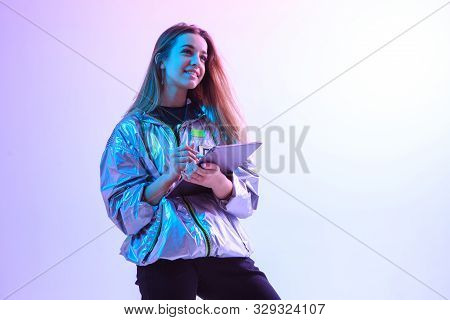 Modern Girl With Laptop, Tablet Computer. Free Creativity. A Young Blogger Makes A Home Office. Colo