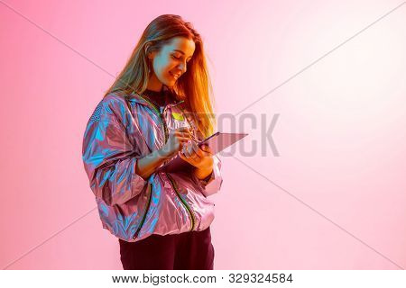 Modern Girl With Laptop, Tablet Computer. Free Creativity. A Young Blogger Makes A Home Office. Colo