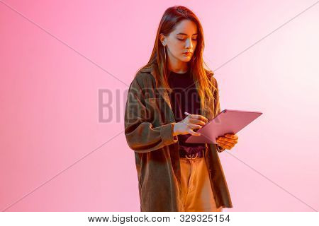 Modern Girl With Laptop, Tablet Computer. Free Creativity. A Young Blogger Makes A Home Office. Colo