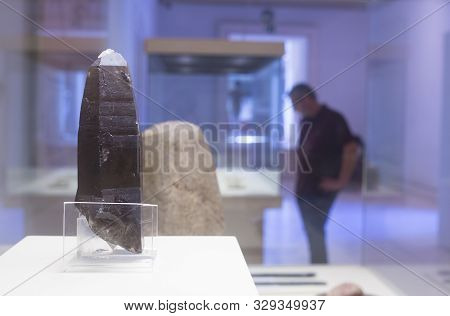 Cadiz, Spain - May 31th, 2019: Prehistoric Silex Knife. Visitor Standing At Bottom. Cadiz Museum, Sp
