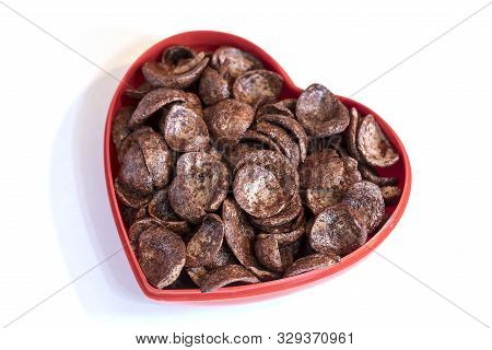Chocolate Cereal Inside A Heart Shaped Container With White Background