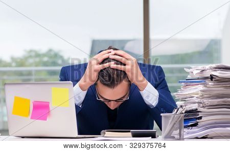 Workaholic businessman overworked with too much work in office