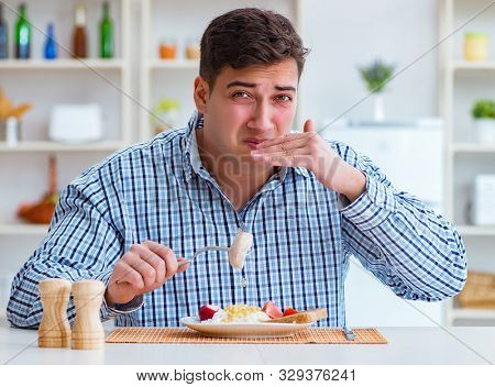 Man eating tasteless food at home for lunch