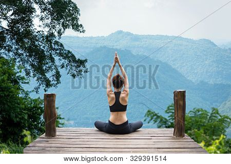Healthy Woman Lifestyle Balanced Practicing Meditate And Zen Energy Yoga Outdoors On The Bridge In M