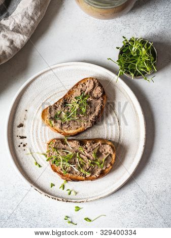 Two Toasts Chicken Rillettes (pate) On White Bread With Sprouts On White Plate On A Light Background