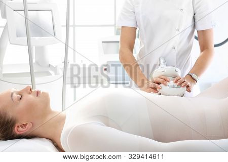 Flat Stomach, A Woman During A Vacuum Massage Treatment Using A Professional Device. Endermologie