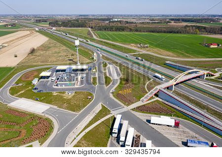 View From The Top Of The Highway, Adjacent Gas Station And Truck Stop. There Is A Pedestrian Bridge 