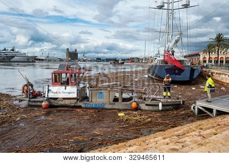 TARRAGONA, SPAIN - OCTOBER 23, 2019: A view of the Port Tarraco marina in Tarragona, Spain, with the dirt of the flood of the Francoli River, the day before, on the surface of the water