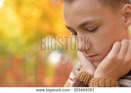 Portrait Of A Sad Little Boy Outdoors