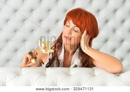 Portrait Of Beautiful Redhead Mature Woman Posing