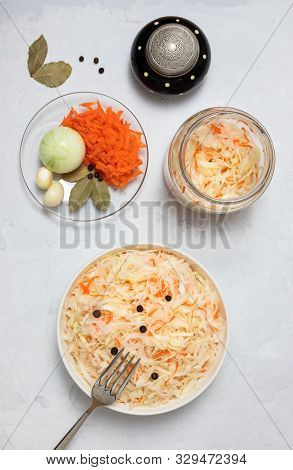 Homemade Sauerkraut. Fermented Food. Sauerkraut With Carrots In A Bowl And Glass Jar On A Concrete W