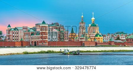 Orthodox Christian Church On The Embankment Of River At Sunset, Ith Electric Illumination. Kokshaga 