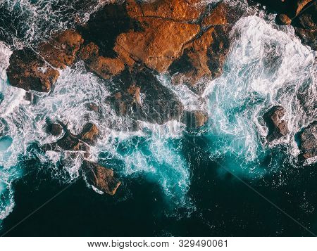 Stunning Birds Eye View Of Ocean Waves Crashing Against The Cliffs, Sydney Coastwalk, Australia.