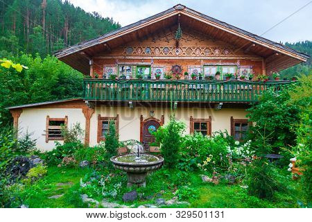 Altai, Russia - 08.01.2019: A Small Cute House Outside The City For Summer Living And Outdoor Recrea