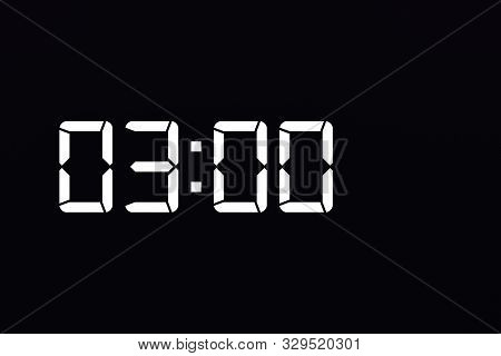 Showing Time 03:00 On White Led Digital Clock Isolated Black Background