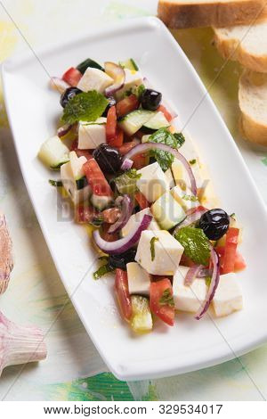 Greek salad with feta cheese cubes and fresk vegetables