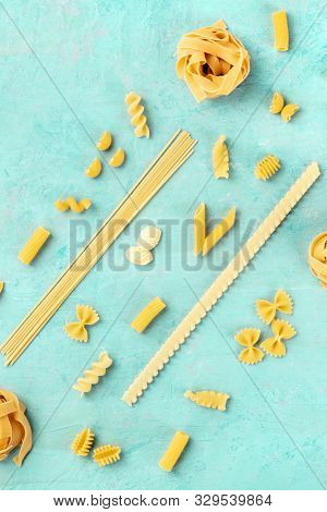 Italian Pasta Variety, Flatlay Banner, Overhead Shot On A Teal Blue Background With Copyspace