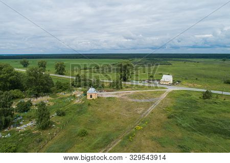 Lonely House, Road, Old Chapel And Cemetery Among The Trees And Fields. Aerial, Summer, Cloudy