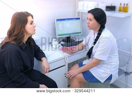 Woman In Consultation With A Trichologist In Clinic Talking About Her Problems With Hairs. Woman Doc