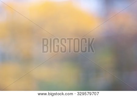 Autumn Blurred Background With Bokeh Effect. Blurred Soft Image Of An Autumn Park. Natural Backgroun