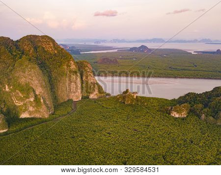 Aerial Top View Of Samet Nangshe And Tropical Green Forest Trees At Sunset With Andaman Sea In Phang