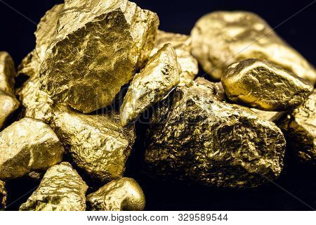 Golden Nuggets Isolated On Black Background. Luxury Concept.
