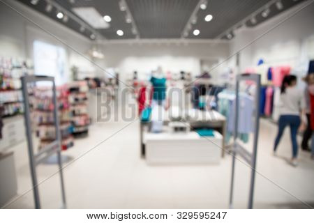Blurred View Of Clothing Store With Canner Entrance Gate For Prevent Theft