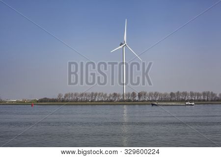 Netherlands, New Waterway. Container Ship In Front Of Modern Windmill Shipping, Transport And Heavy 