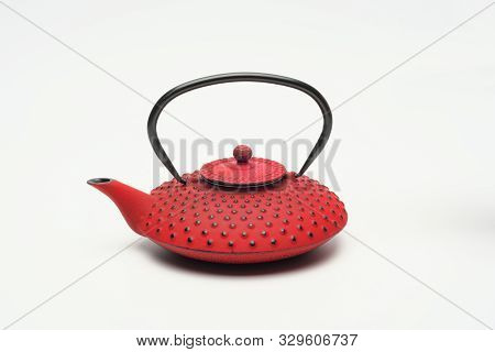 Red Cast Iron Teapot On A White Background.