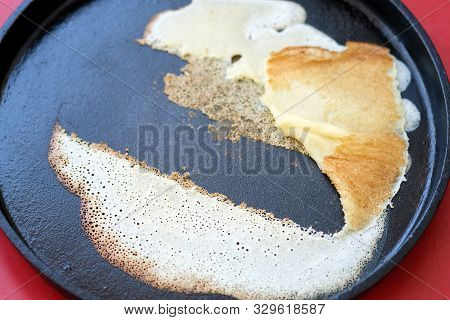 Pancake Stuck To A Pan For Baking Pancakes. A Thin Pancake Stuck To The Pan. The First Pancake Is Lu
