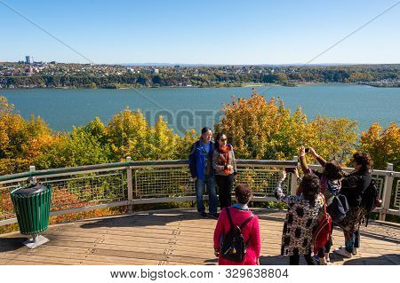Quebec City, Ca - 5 October 2019 - Tourists Posing For Pictures In Front Of Saint-lawrence River And