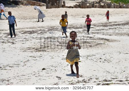 Pingwe, Zanzibar - October 6, 2019: Cheerful Happy Children On The Pingwe Beach, Local Village On Ba