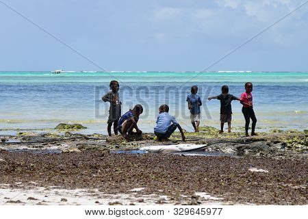 Pingwe, Zanzibar - October 6, 2019: Cheerful Happy Children On The Pingwe Beach During Low Tide. Tan