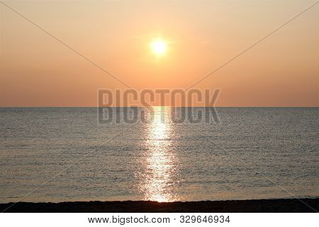 Orange Sun And The Reflection On The Water Of The Sea