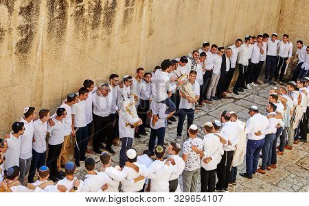 Jerusalem, Israel - October 21, 2019: A Group Of Religious People Celebrate Simchat Torah. Sing Song