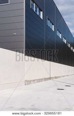 Industrial Building Facade With Metallic Cladding. Industrial Warehouse. Construction Elements Of Mo