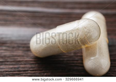 White Medical Capsules Of Glucosamine Chondroitin, Healthy Supplement Pills On Wooden Background, Ma